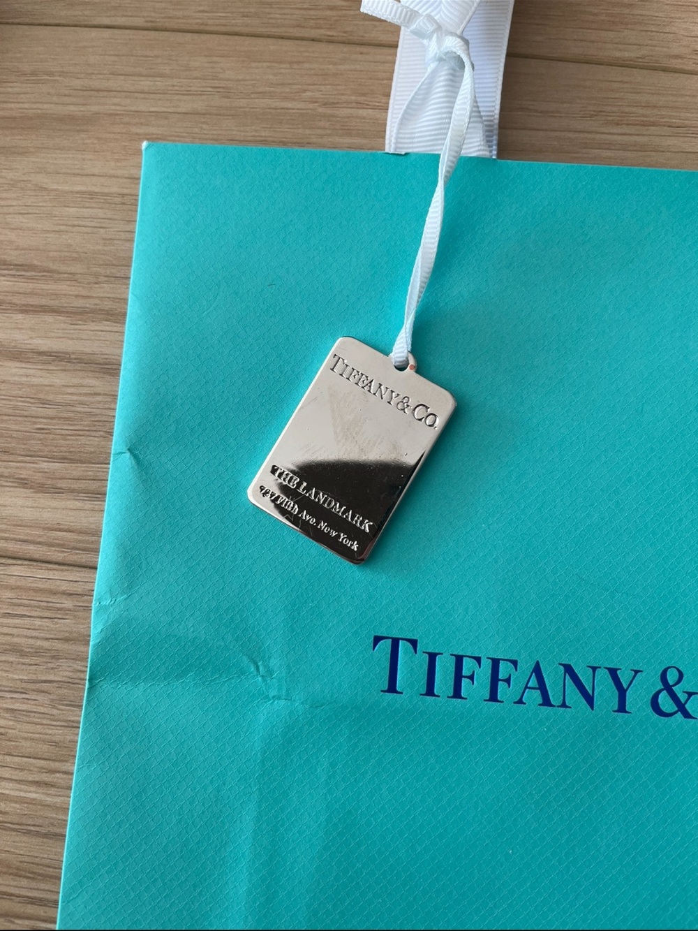 Tiffany & Co. Flagship blue paper bag with engraved charm